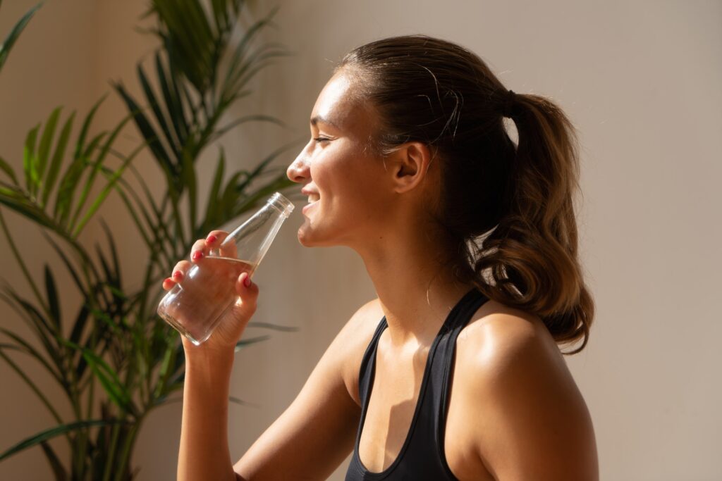 sporty woman drinking water